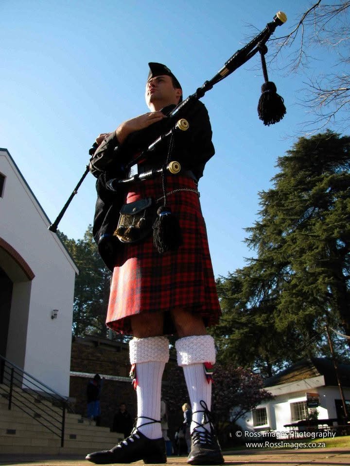 Piper Paul in formal Highland attire with bagpipes