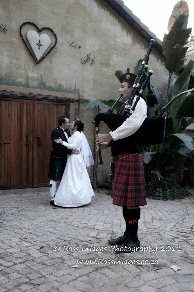 Piper Paul playing bagpipes while a wedding couple celebrates nearby